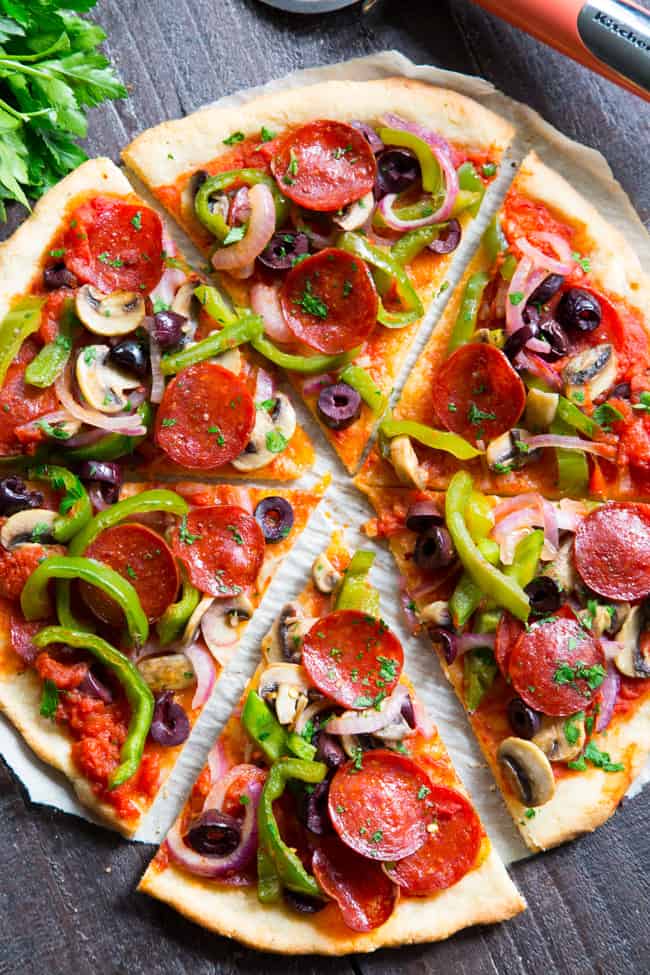 This paleo pepperoni pizza is loaded with all your favorite veggies and packed with flavor!  It's baked on the perfect paleo pizza crust and is totally dairy free, gluten free, grain free and soy free.  This healthy pizza is family approved and easy to make, too! 