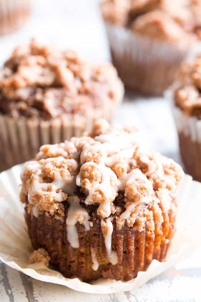 These paleo pumpkin muffins with cinnamon streusel are everything I love about fall baking!  Moist, sweetly spiced pumpkin muffins are topped with the perfect streusel plus an optional maple icing!  They’re a kid favorite and happen to be gluten-free, grain free, and have a tested dairy free option.