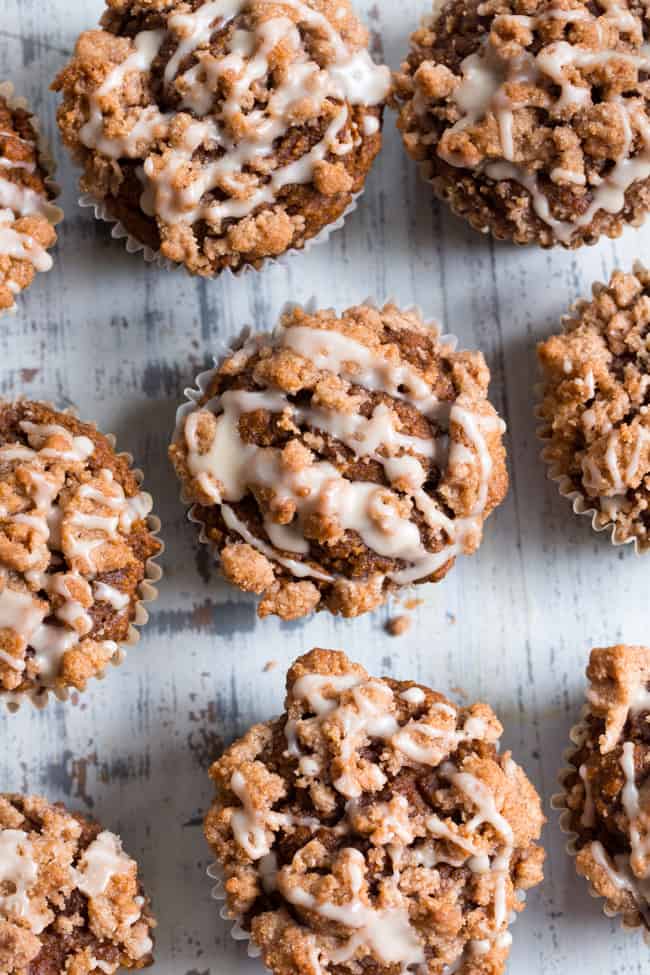 These paleo pumpkin muffins with cinnamon streusel are everything I love about fall baking!  Moist, sweetly spiced pumpkin muffins are topped with the perfect streusel plus an optional maple icing!  They’re a kid favorite and happen to be gluten-free, grain free, and have a tested dairy free option.