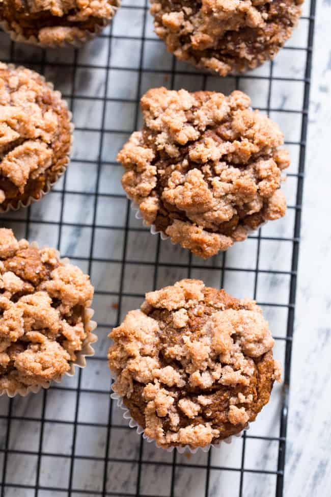 These paleo pumpkin muffins with cinnamon streusel are everything I love about fall baking!  Moist, sweetly spiced pumpkin muffins are topped with the perfect streusel plus an optional maple icing!  They’re a kid favorite and happen to be gluten-free, grain free, and have a tested dairy free option.