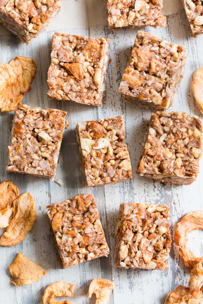 These grain free, vegan, and paleo granola bars are packed with warm spices and chopped dried apples for a fun fall touch!  They're sweetened with pure maple syrup and contain no refined sugar, grains or dairy.  They're chewy, crunchy, family approved and perfect for after school snacks!