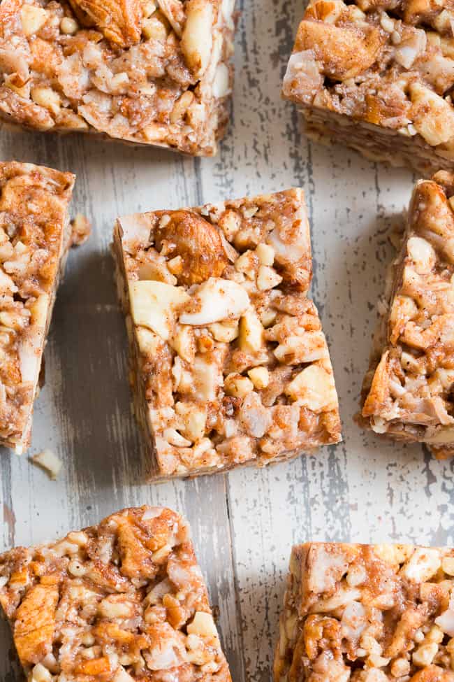 These grain free, vegan, and paleo granola bars are packed with warm spices and chopped dried apples for a fun fall touch!  They're sweetened with pure maple syrup and contain no refined sugar, grains or dairy.  They're chewy, crunchy, family approved and perfect for after school snacks!