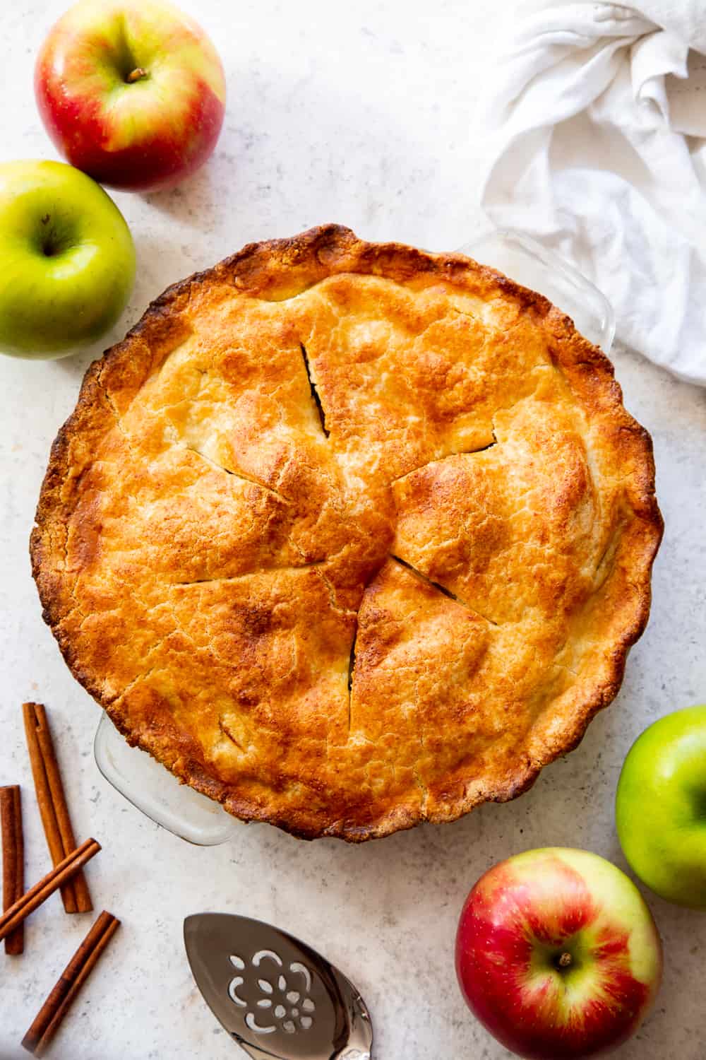 This classic Paleo Apple Pie has an easy double crust made with a dairy free option and is loaded with juicy gooey apples, warm spices and sweetened naturally with pure maple sugar.  It's a family favorite and perfect for Thanksgiving or any special celebration this fall!  #paleo #applepie #glutenfree #apples #cleaneating #paleobaking #glutenfreebaking