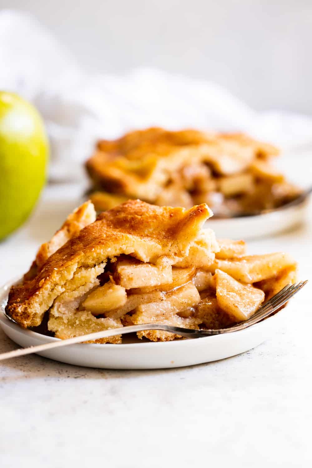 This classic Paleo Apple Pie has an easy double crust made with a dairy free option and is loaded with juicy gooey apples, warm spices and sweetened naturally with pure maple sugar.  It's a family favorite and perfect for Thanksgiving or any special celebration this fall!  #paleo #applepie #glutenfree #apples #cleaneating #paleobaking #glutenfreebaking