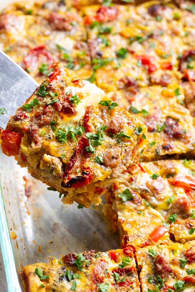 This Italian breakfast casserole is packed with goodies!  Sausage, sun dried tomatoes, peppers, onions, garlic, spices, and a creamy egg mixture!  It's Paleo and Whole30 compliant, great to make ahead, and family approved. 