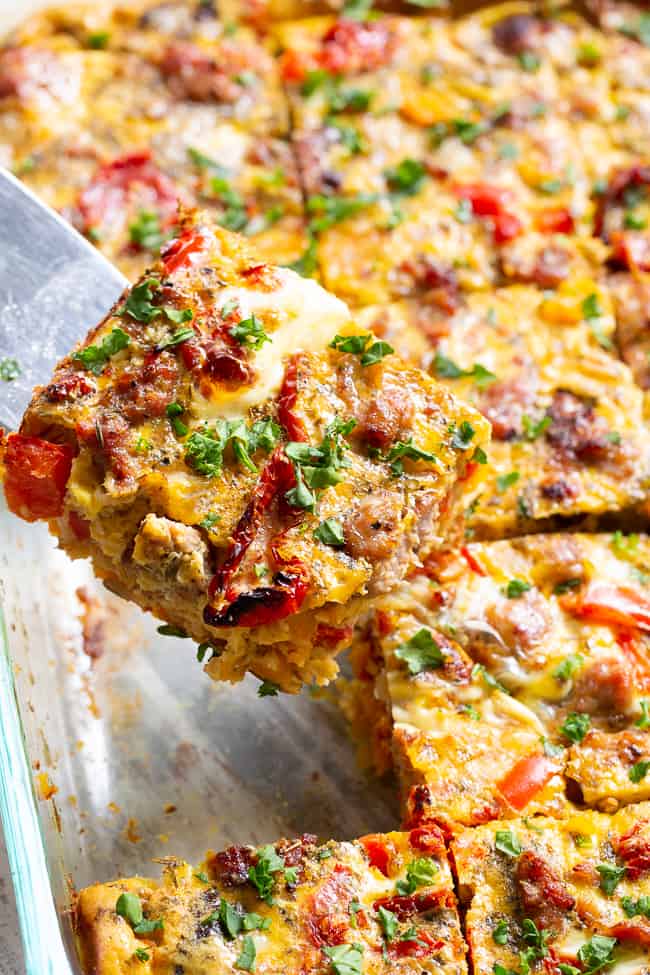 This Italian breakfast casserole is packed with goodies!  Sausage, sun dried tomatoes, peppers, onions, garlic, spices, and a creamy egg mixture!  It's Paleo and Whole30 compliant, great to make ahead, and family approved. 