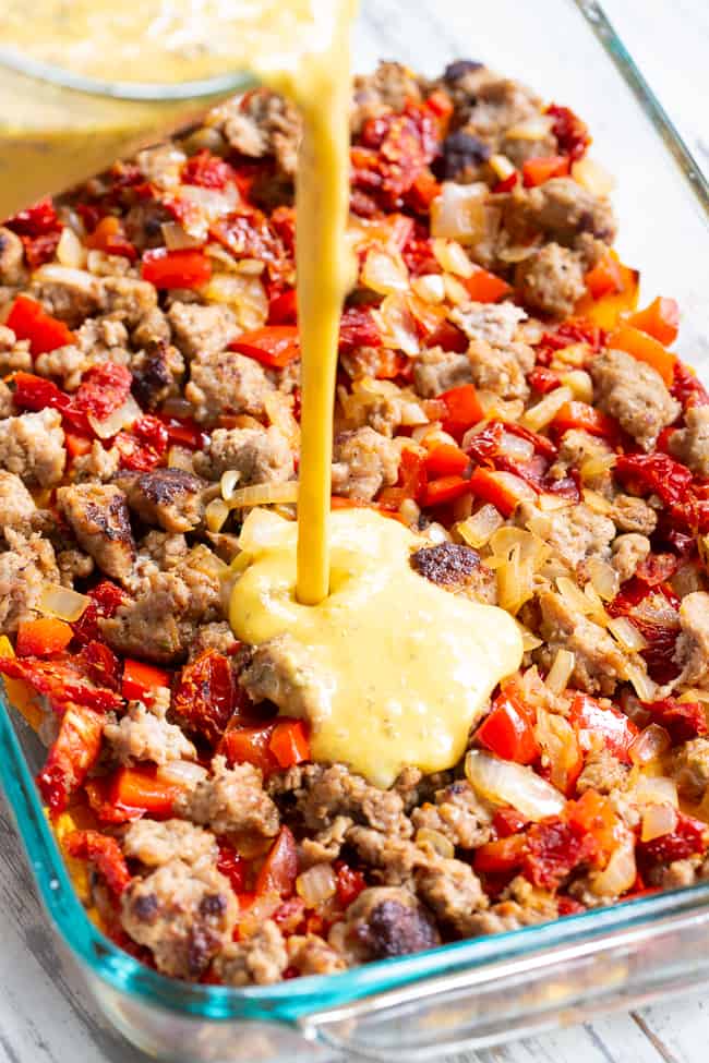 This Italian breakfast casserole is packed with goodies!  Sausage, sun dried tomatoes, peppers, onions, garlic, spices, and a creamy egg mixture!  It's Paleo and Whole30 compliant, great to make ahead, and family approved. 