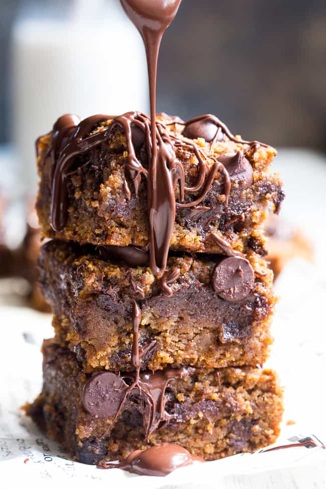 These fudgy pumpkin blondies are a dream!  They're chewy, sweet, packed with chocolate and warm spices.  Family approved, perfect for fall baking or any time of year.  These addicting pumpkin blondies are paleo, dairy-free, and gluten-free.