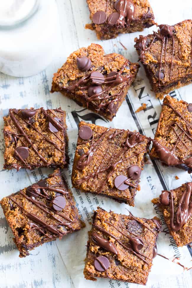 These fudgy pumpkin blondies are a dream!  They're chewy, sweet, packed with chocolate and warm spices.  Family approved, perfect for fall baking or any time of year.  These addicting pumpkin blondies are paleo, dairy-free, and gluten-free.