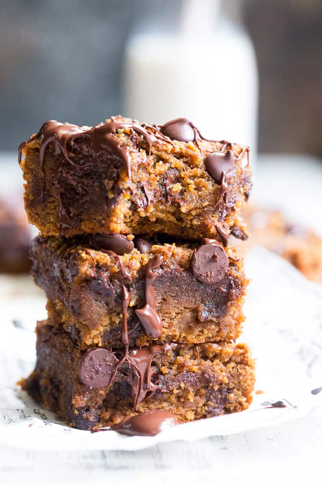 These fudgy pumpkin blondies are a dream!  They're chewy, sweet, packed with chocolate and warm spices.  Family approved, perfect for fall baking or any time of year.  These addicting pumpkin blondies are paleo, dairy-free, and gluten-free.