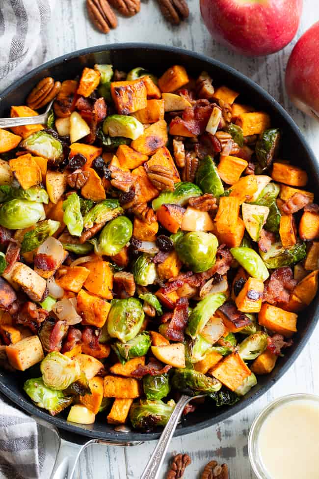 This harvest hash is everything you’re craving for the fall season, or anytime!  It’s loaded with roasted veggies, apples, bacon, pecans and raisins for a sweet, savory and healthy dish!  The apple vinaigrette add the perfect final touch!  Paleo, Whole30 compliant and great for any meal or as a holiday side dish!