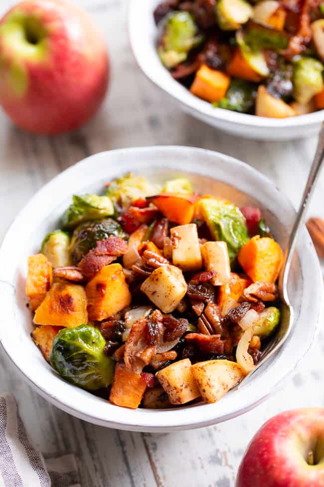 This harvest hash is everything you’re craving for the fall season, or anytime!  It’s loaded with roasted veggies, apples, bacon, pecans and raisins for a sweet, savory and healthy dish!  The apple vinaigrette add the perfect final touch!  Paleo, Whole30 compliant and great for any meal or as a holiday side dish!