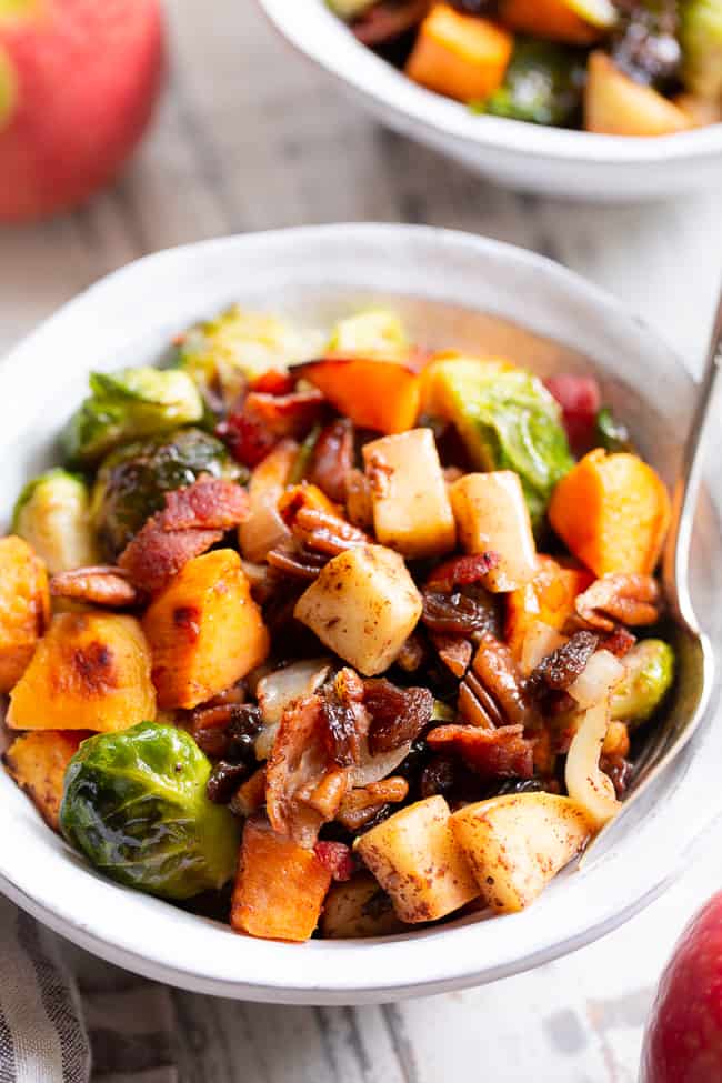 This harvest hash is everything you’re craving for the fall season, or anytime!  It’s loaded with roasted veggies, apples, bacon, pecans and raisins for a sweet, savory and healthy dish!  The apple vinaigrette add the perfect final touch!  Paleo, Whole30 compliant and great for any meal or as a holiday side dish!