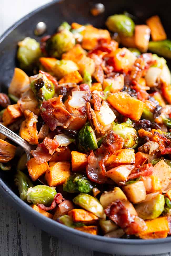 This harvest hash is everything you’re craving for the fall season, or anytime!  It’s loaded with roasted veggies, apples, bacon, pecans and raisins for a sweet, savory and healthy dish!  The apple vinaigrette add the perfect final touch!  Paleo, Whole30 compliant and great for any meal or as a holiday side dish!