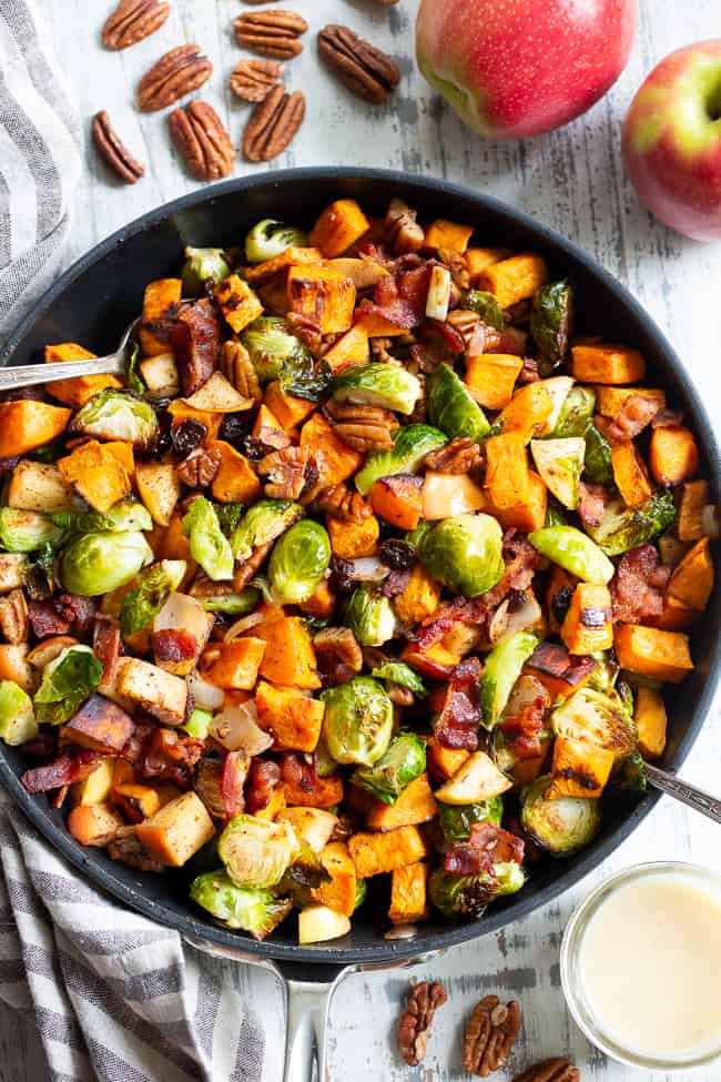 This harvest hash is everything you’re craving for the fall season, or anytime!  It’s loaded with roasted veggies, apples, bacon, pecans and raisins for a sweet, savory and healthy dish!  The apple vinaigrette add the perfect final touch!  Paleo, Whole30 compliant and great for any meal or as a holiday side dish!