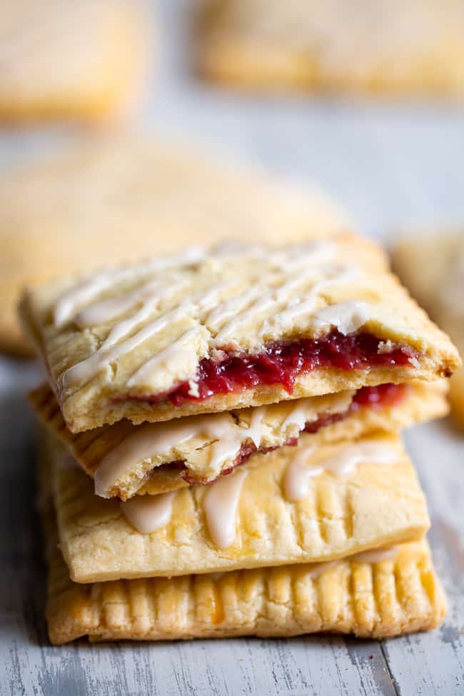 These strawberry homemade pop tarts have passed all the tests!  Gooey maple-sweetened strawberry filling in a flaky grain free pastry crust with a dairy free option.  Gluten-free, paleo, kid approved, fun to make and freezable! #paleo #glutenfree #poptarts