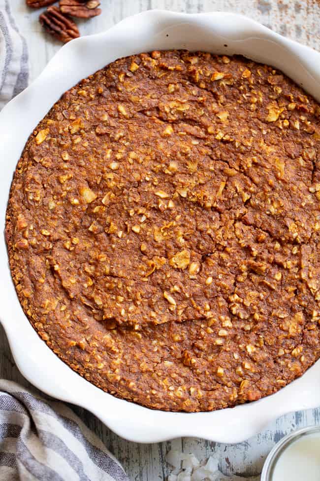 This pumpkin "oatmeal" bake is totally grain free yet tastes just like classic baked oatmeal.  It's packed with pumpkin and pumpkin pie spices, and pure maple syrup adds just the right amount of sweetness.  It reheats perfectly, making it a great fall comfort food breakfast when you're on the go!  Paleo, dairy-free, egg free, and vegan.