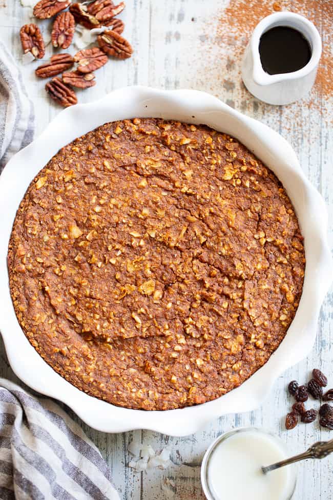 This pumpkin "oatmeal" bake is totally grain free yet tastes just like classic baked oatmeal.  It's packed with pumpkin and pumpkin pie spices, and pure maple syrup adds just the right amount of sweetness.  It reheats perfectly, making it a great fall comfort food breakfast when you're on the go!  Paleo, dairy-free, egg free, and vegan.