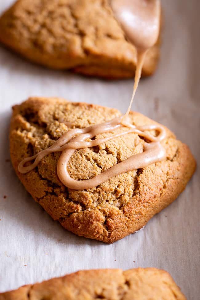 These paleo pumpkin scones are tender and full of pumpkin spice flavor!  Serve them warm topped with a pumpkin spice drizzle for a special (healthier!) treat this fall.  Gluten free and paleo with dairy-free options.  Paleo baking. Paleo desserts. Paleo scones. Paleo Pumpkin recipes.