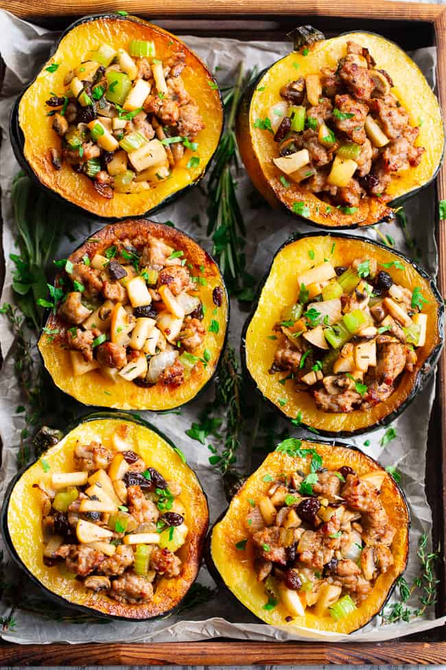 This roasted acorn squash is stuffed to the max with absolutely everything you’re craving!  Savory sausage, veggies, and herbs with sweet apples and raisins make this the ultimate stuffed roasted acorn squash this season!  Paleo, dairy-free, and Whole30 compliant.  Perfect for Thanksgiving and the holidays or anytime! Paleo Thanksgiving. Paleo holidays. Paleo recipes. Paleo dinner.