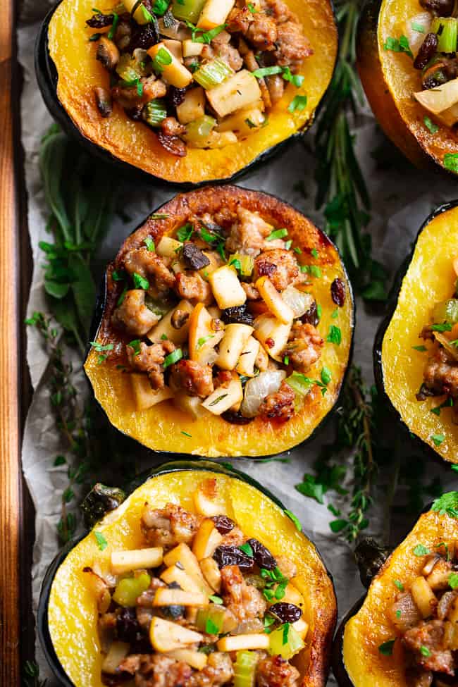 This roasted acorn squash is stuffed to the max with absolutely everything you’re craving!  Savory sausage, veggies, and herbs with sweet apples and raisins make this the ultimate stuffed roasted acorn squash this season!  Paleo, dairy-free, and Whole30 compliant.  Perfect for Thanksgiving and the holidays or anytime! Paleo Thanksgiving. Paleo holidays. Paleo recipes. Paleo dinner.