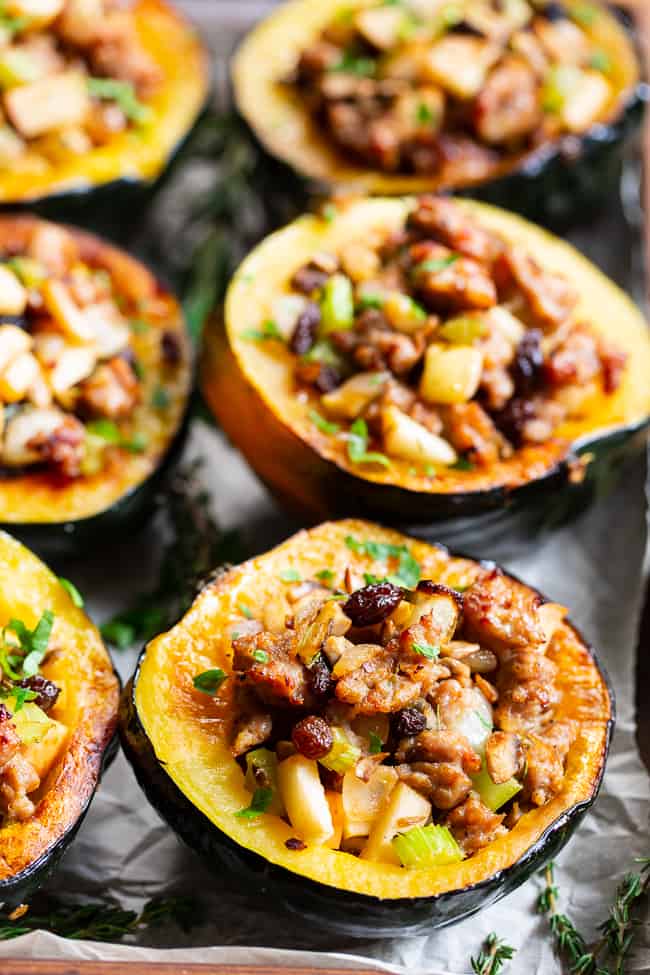 This roasted acorn squash is stuffed to the max with absolutely everything you’re craving!  Savory sausage, veggies, and herbs with sweet apples and raisins make this the ultimate stuffed roasted acorn squash this season!  Paleo, dairy-free, and Whole30 compliant.  Perfect for Thanksgiving and the holidays or anytime! Paleo Thanksgiving. Paleo holidays. Paleo recipes. Paleo dinner.