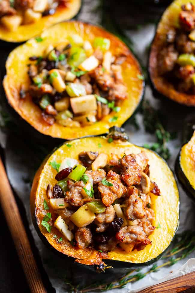 This roasted acorn squash is stuffed to the max with absolutely everything you’re craving!  Savory sausage, veggies, and herbs with sweet apples and raisins make this the ultimate stuffed roasted acorn squash this season!  Paleo, dairy-free, and Whole30 compliant.  Perfect for Thanksgiving and the holidays or anytime! Paleo Thanksgiving. Paleo holidays. Paleo recipes. Paleo dinner.