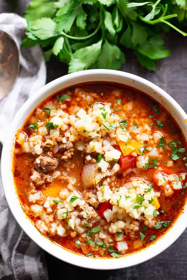 This stuffed pepper soup is loaded with everything you’re craving!  Italian spices, savory ground beef, garlic and onions, bell peppers, and cauliflower “rice” make this a hearty soup that’s also super healthy for you.  Gluten-free, dairy-free, keto and Whole30 friendly.