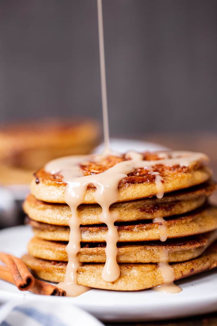 These grain free and paleo cinnamon roll pancakes have a gooey cinnamon swirl and maple glaze for the best of all things cinnamon roll without the work!   Family approved, gluten-free, with a dairy-free option. Paleo breakfast.  Gluten-free pancakes.  Paleo pancakes.  Paleo Christmas recipes.  Paleo Christmas.