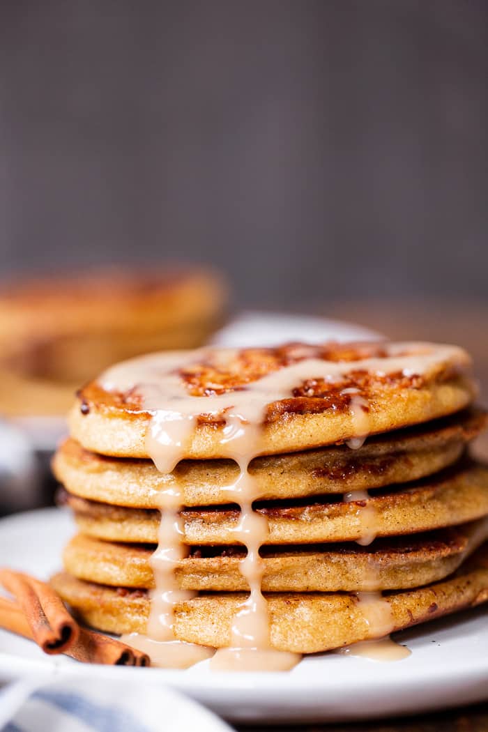 These grain free and paleo cinnamon roll pancakes have a gooey cinnamon swirl and maple glaze for the best of all things cinnamon roll without the work!   Family approved, gluten-free, with a dairy-free option. Paleo breakfast.  Gluten-free pancakes.  Paleo pancakes.  Paleo Christmas recipes.  Paleo Christmas.