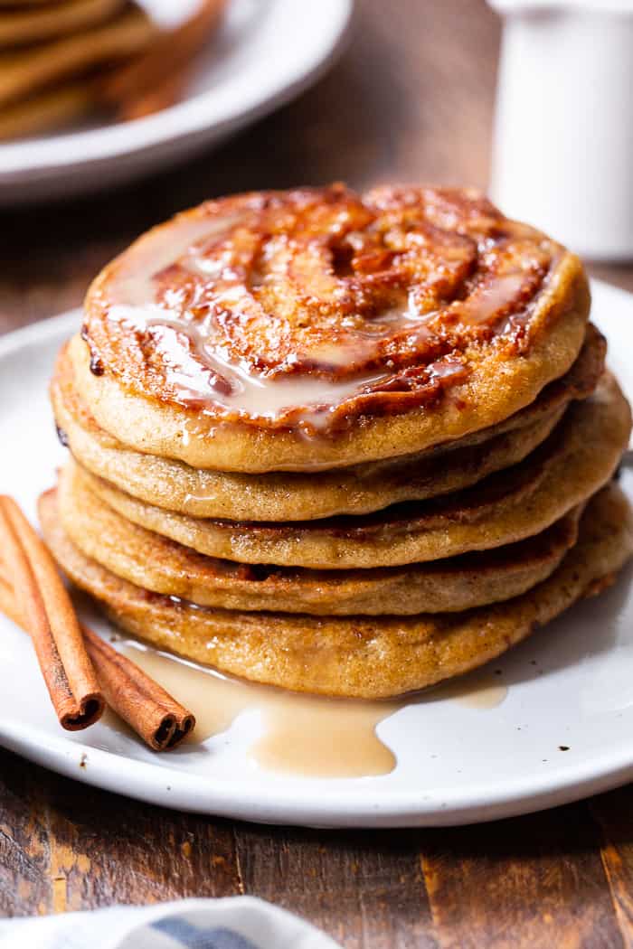 These grain free and paleo cinnamon roll pancakes have a gooey cinnamon swirl and maple glaze for the best of all things cinnamon roll without the work!   Family approved, gluten-free, with a dairy-free option. Paleo breakfast.  Gluten-free pancakes.  Paleo pancakes.  Paleo Christmas recipes.  Paleo Christmas.