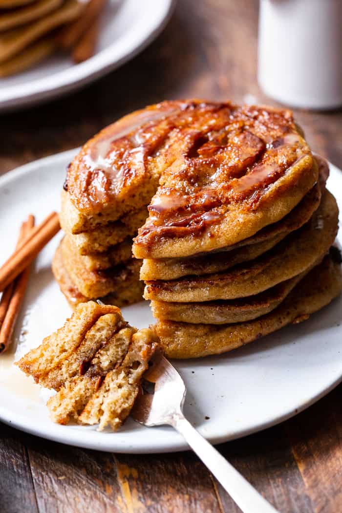 These grain free and paleo cinnamon roll pancakes have a gooey cinnamon swirl and maple glaze for the best of all things cinnamon roll without the work!   Family approved, gluten-free, with a dairy-free option. Paleo breakfast.  Gluten-free pancakes.  Paleo pancakes.  Paleo Christmas recipes.  Paleo Christmas.