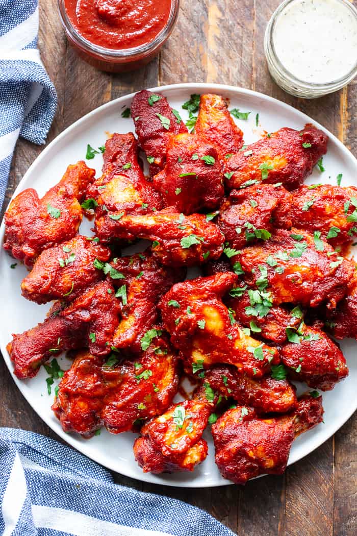 These sweet and smoky BBQ chicken wings are made Whole30 compliant with an easy homemade BBQ sauce.  They’re baked to crispy perfection and brushed with lots of sauce for a super tasty appetizer or main course that you’ll be constantly craving! 
