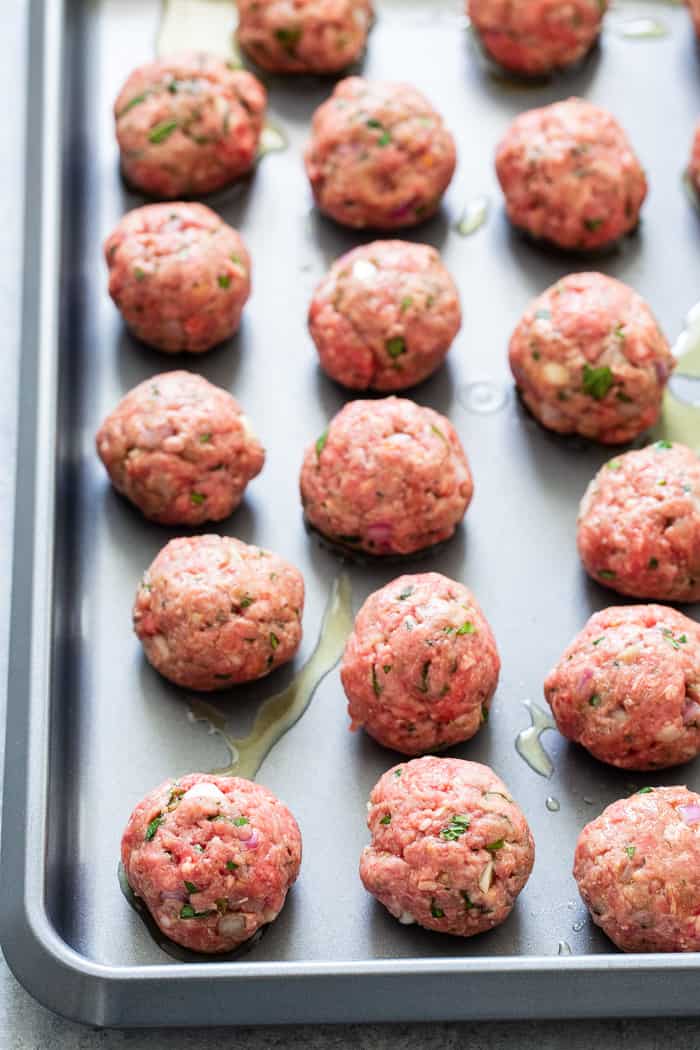 These easy greek meatballs are perfectly flavorful and delicious dipped in a dairy-free paleo Tzatziki sauce!   Great as an appetizer or as part of a meal over a greek salad.  Paleo, Whole30, and keto friendly.