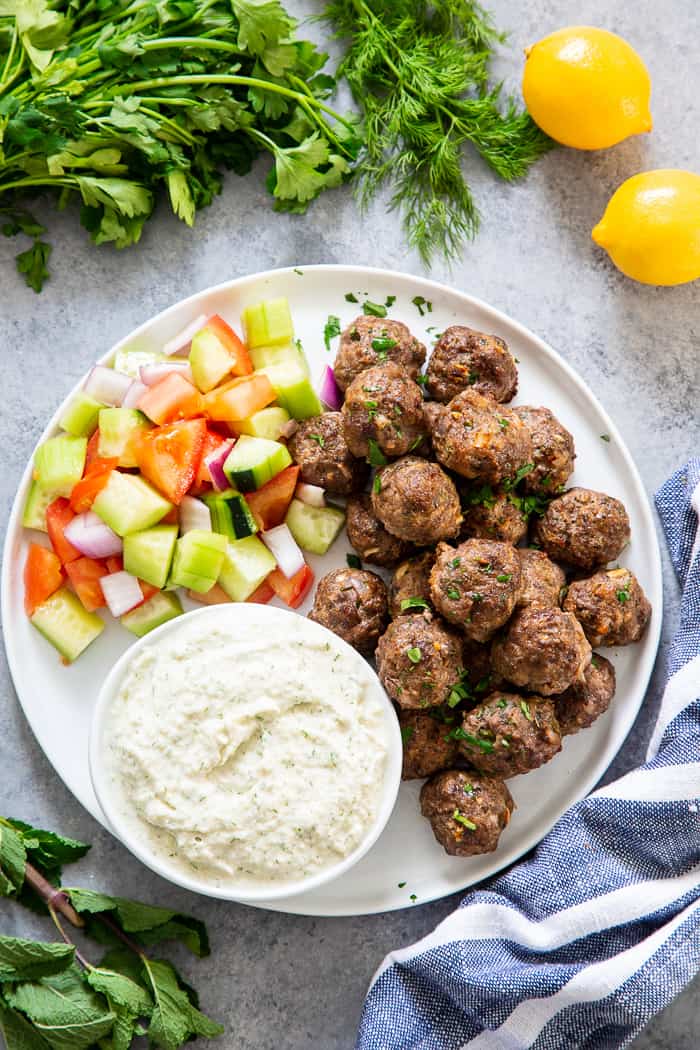 These easy greek meatballs are perfectly flavorful and delicious dipped in a dairy-free paleo Tzatziki sauce!   Great as an appetizer or as part of a meal over a greek salad.  Paleo, Whole30, and keto friendly.