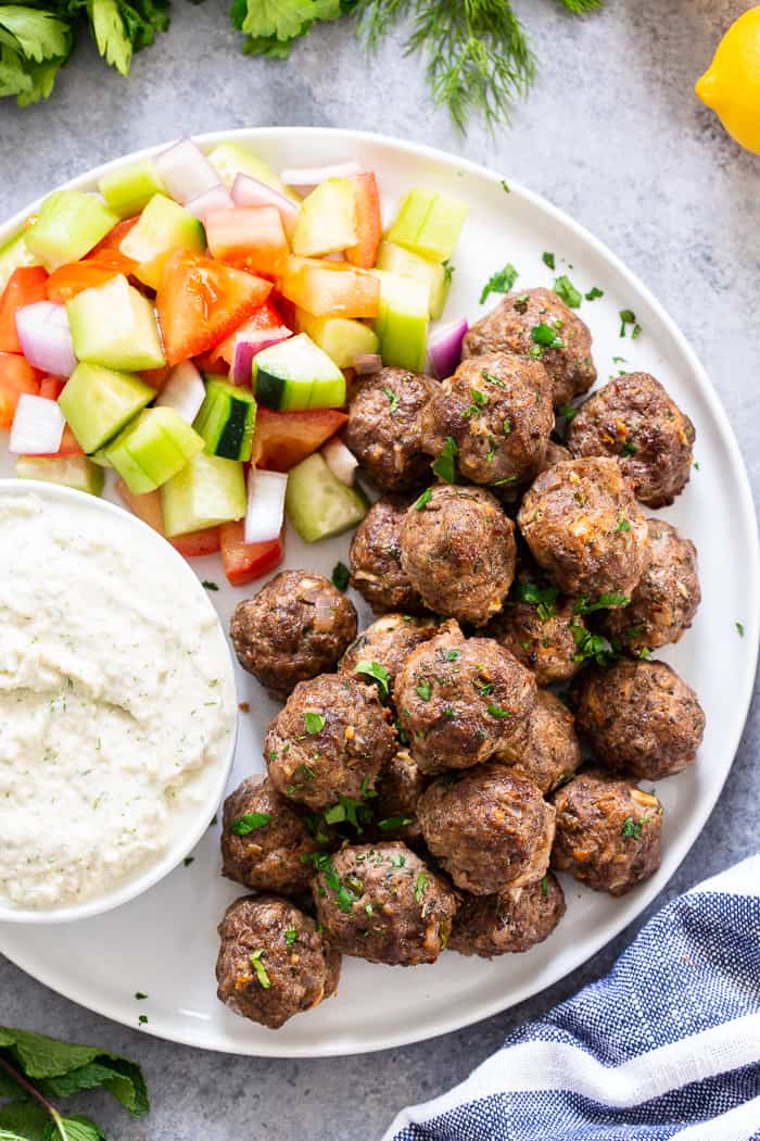 These easy greek meatballs are perfectly flavorful and delicious dipped in a dairy-free paleo Tzatziki sauce!   Great as an appetizer or as part of a meal over a greek salad.  Paleo, Whole30, and keto friendly.