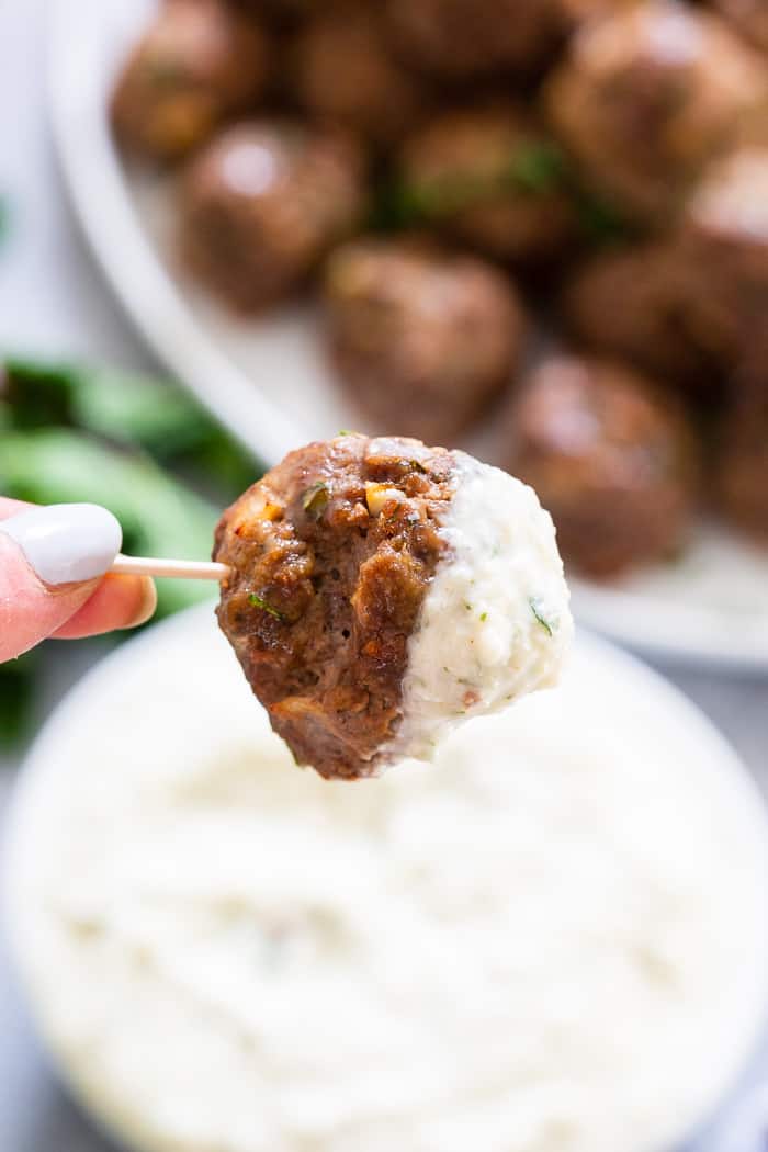 These easy greek meatballs are perfectly flavorful and delicious dipped in a dairy-free paleo Tzatziki sauce!   Great as an appetizer or as part of a meal over a greek salad.  Paleo, Whole30, and keto friendly.