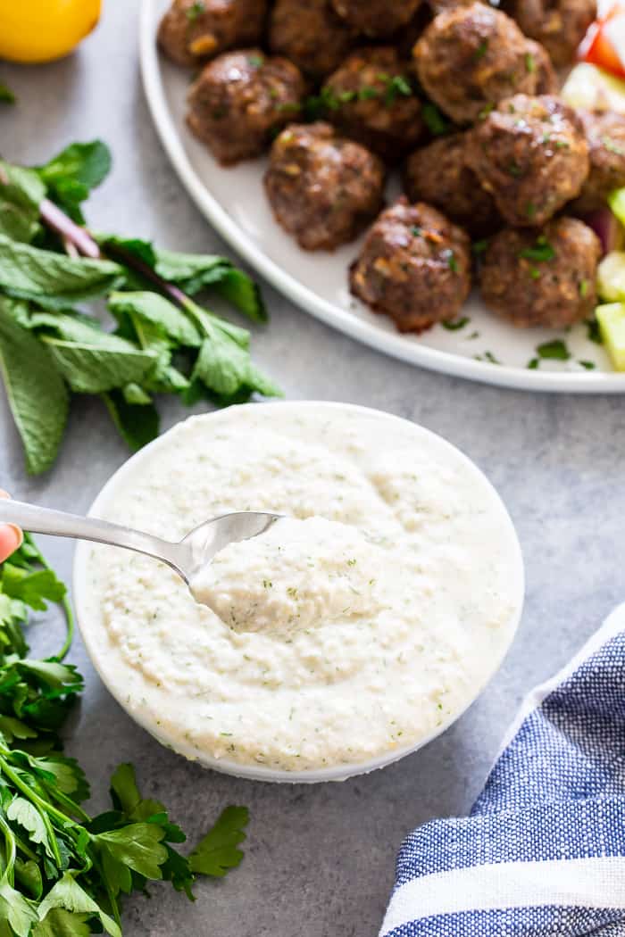 These easy greek meatballs are perfectly flavorful and delicious dipped in a dairy-free paleo Tzatziki sauce!   Great as an appetizer or as part of a meal over a greek salad.  Paleo, Whole30, and keto friendly.