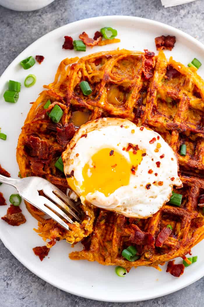 These savory bacon and sweet potato waffles are crisp on the outside, packed with tons of flavor and a fun weekend breakfast or brunch!  Top them with fried eggs and more crispy bacon for a super tasty, filling, wholesome meal that you’ll want to make again and again!  Paleo and Whole30 friendly. #AD @JonesDairyFarm #JonesDairyFarm