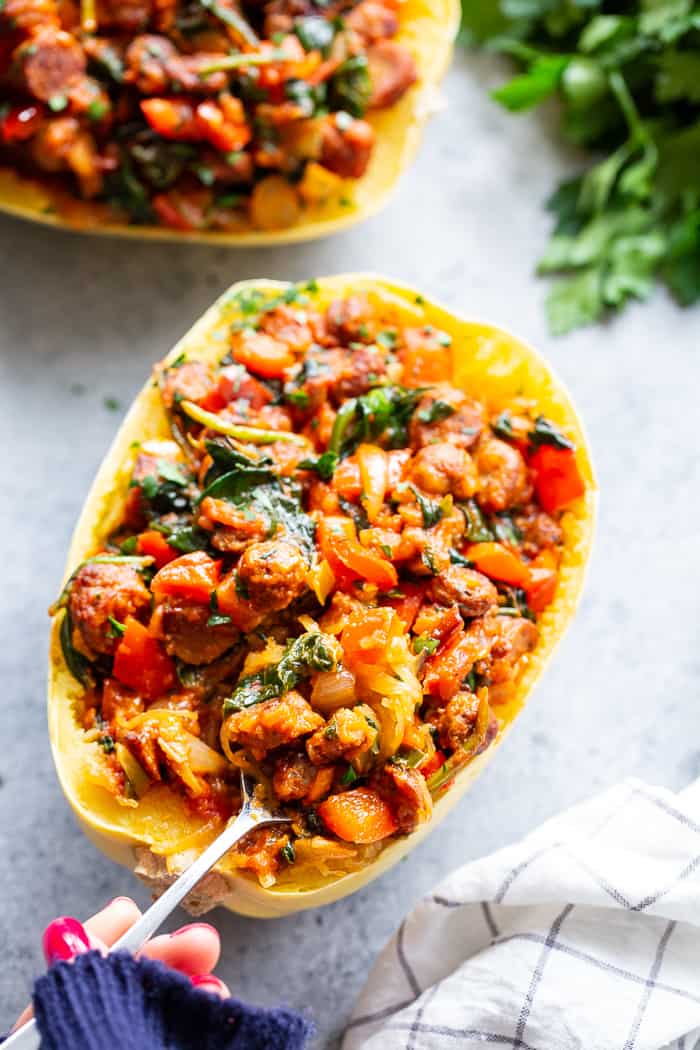 These Instant Pot Spaghetti Squash Boats are loaded with all the yummy things! Sugar free, antibiotic free turkey sausage, onions, peppers, garlic, spinach and marinara make this a healthy, filling dinner that’s paleo, Whole30 compliant and keto friendly too!  #AD @jonesdairyfarm #JonesDairyFarm 