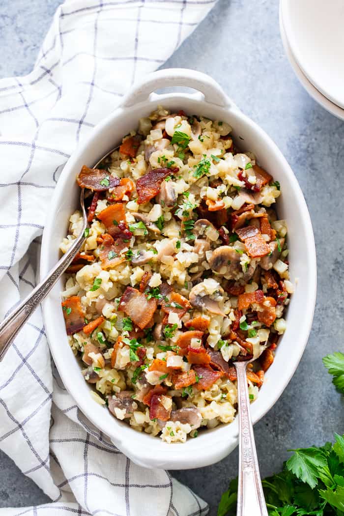 This cauliflower risotto is super easy to make, packed with flavor and savory goodies!  Bacon, mushrooms, and a creamy sauce make this side dish one you’ll want again and again!  It’s dairy-free, paleo, keto friendly and Whole30 compliant. 