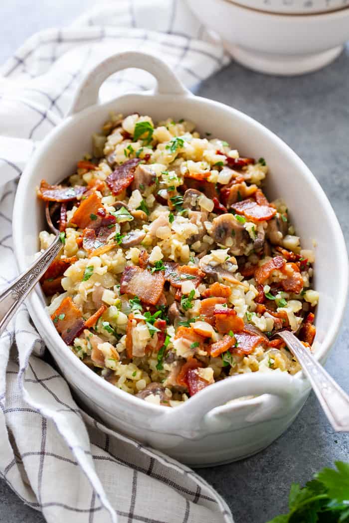 This cauliflower risotto is super easy to make, packed with flavor and savory goodies!  Bacon, mushrooms, and a creamy sauce make this side dish one you’ll want again and again!  It’s dairy-free, paleo, keto friendly and Whole30 compliant. 