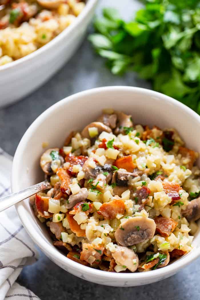 This cauliflower risotto is super easy to make, packed with flavor and savory goodies!  Bacon, mushrooms, and a creamy sauce make this side dish one you’ll want again and again!  It’s dairy-free, paleo, keto friendly and Whole30 compliant. 