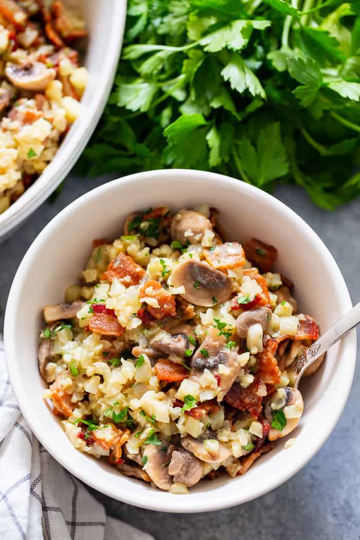 This cauliflower risotto is super easy to make, packed with flavor and savory goodies!  Bacon, mushrooms, and a creamy sauce make this side dish one you’ll want again and again!  It’s dairy-free, paleo, keto friendly and Whole30 compliant. 