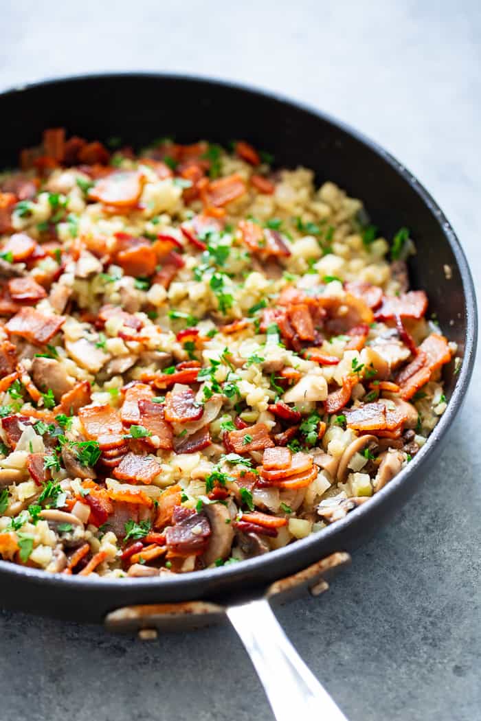 This cauliflower risotto is super easy to make, packed with flavor and savory goodies!  Bacon, mushrooms, and a creamy sauce make this side dish one you’ll want again and again!  It’s dairy-free, paleo, keto friendly and Whole30 compliant. 