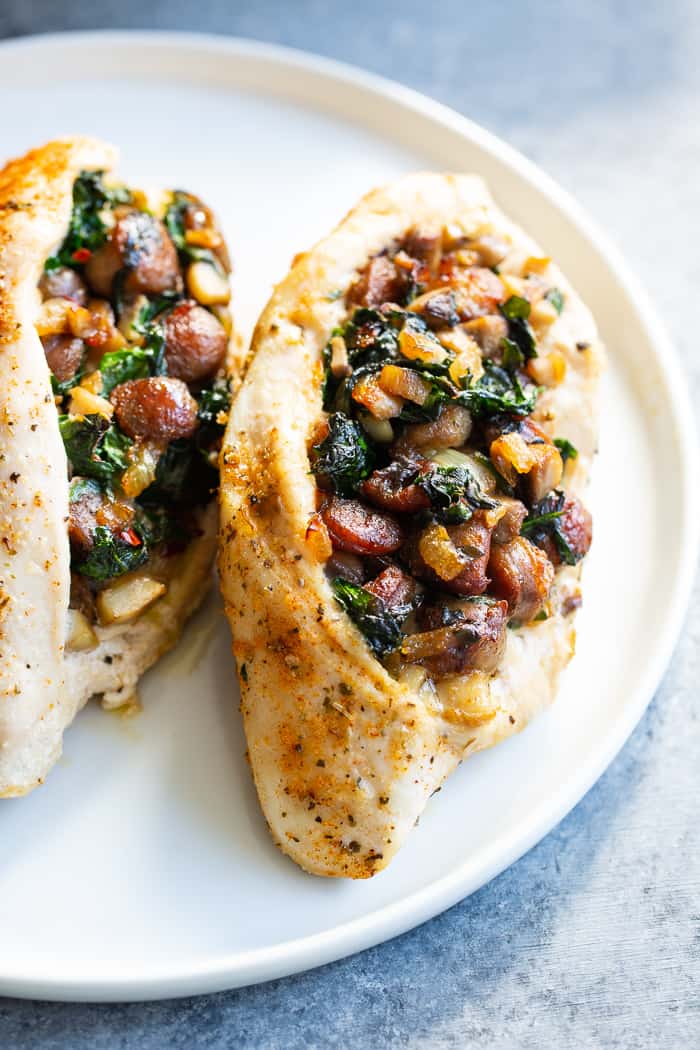 Pinterest: This stuffed chicken is loaded with all your favorite things!  Savory sausage, mushroom, and spinach stuffing baked in seasoned chicken breasts makes this a protein packed, filling meal that’s Paleo, Whole30 and keto friendly!  #AD #JonesDairyFarm