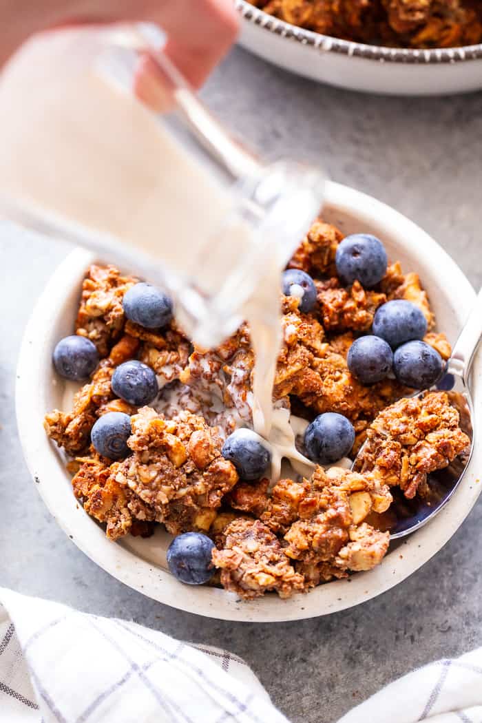 This banana maple nut paleo granola recipe is easy and totally addicting!  It's full of clusters, flavor, and crunch.   Great for topping dairy-free yogurt, as a cereal replacement with almond milk, or snacking on as-is.  It's grain-free, dairy-free, refined sugar free, and vegan.