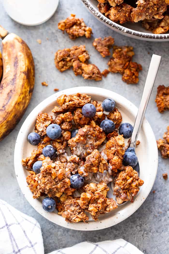 This banana maple nut paleo granola recipe is easy and totally addicting!  It's full of clusters, flavor, and crunch.   Great for topping dairy-free yogurt, as a cereal replacement with almond milk, or snacking on as-is.  It's grain-free, dairy-free, refined sugar free, and vegan.