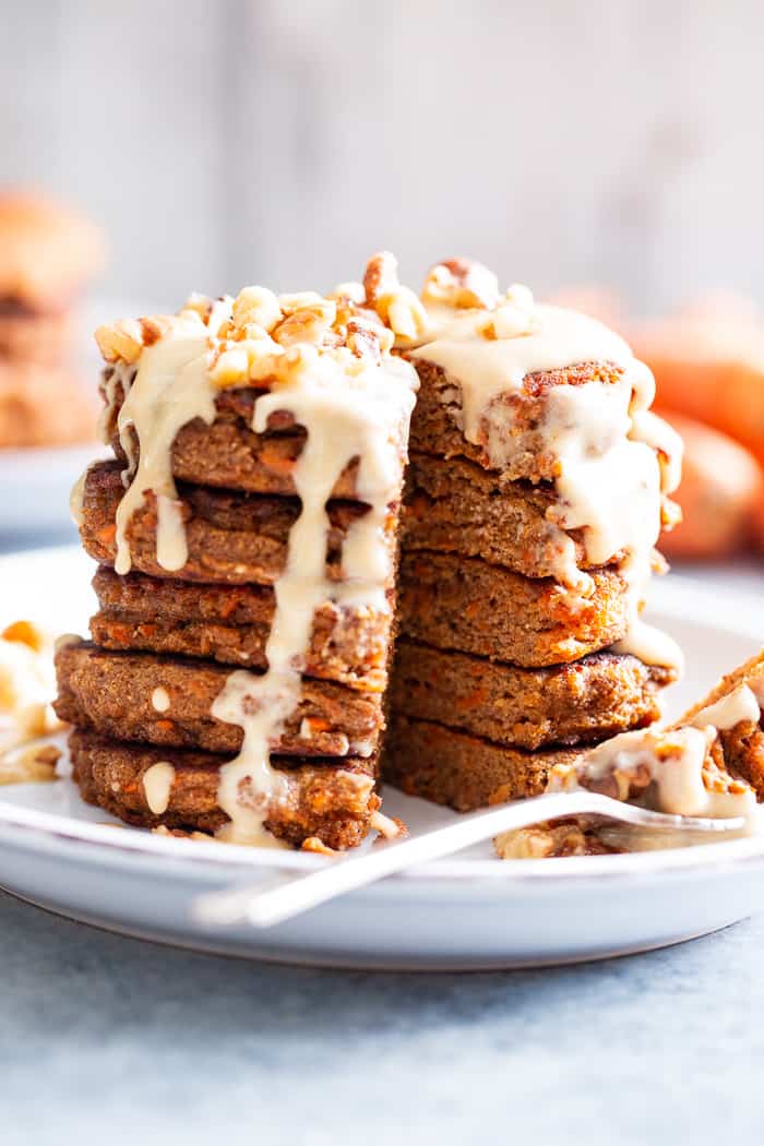 These fluffy, sweet spiced carrot cake pancakes have a dairy-free drizzle that tastes just like a cream cheese icing!  They're made with coconut flour and sweetened with coconut sugar for a healthier take on a Spring breakfast treat.  Gluten-free, dairy-free, refined sugar free, and paleo friendly.