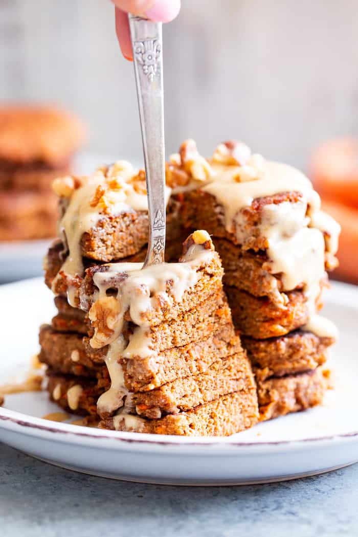 These fluffy, sweet spiced carrot cake pancakes have a dairy-free drizzle that tastes just like a cream cheese icing!  They're made with coconut flour and sweetened with coconut sugar for a healthier take on a Spring breakfast treat.  Gluten-free, dairy-free, refined sugar free, and paleo friendly.